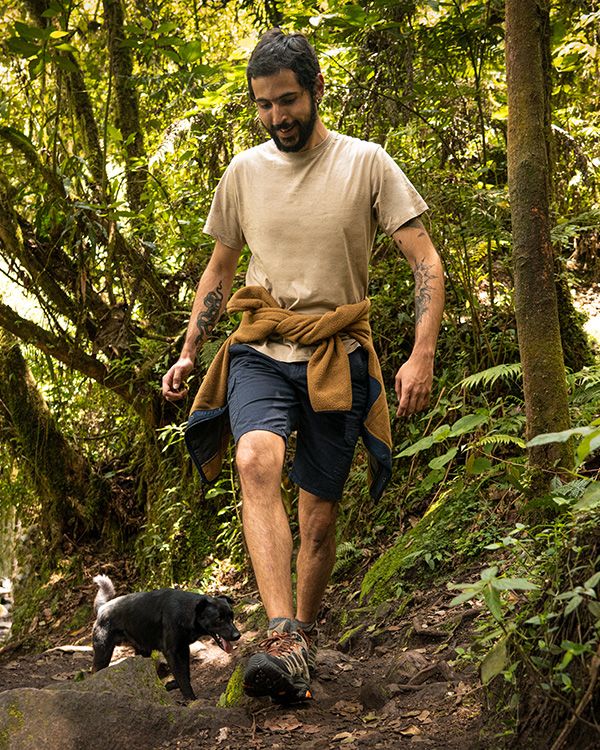A person walking with a dog on a trail.