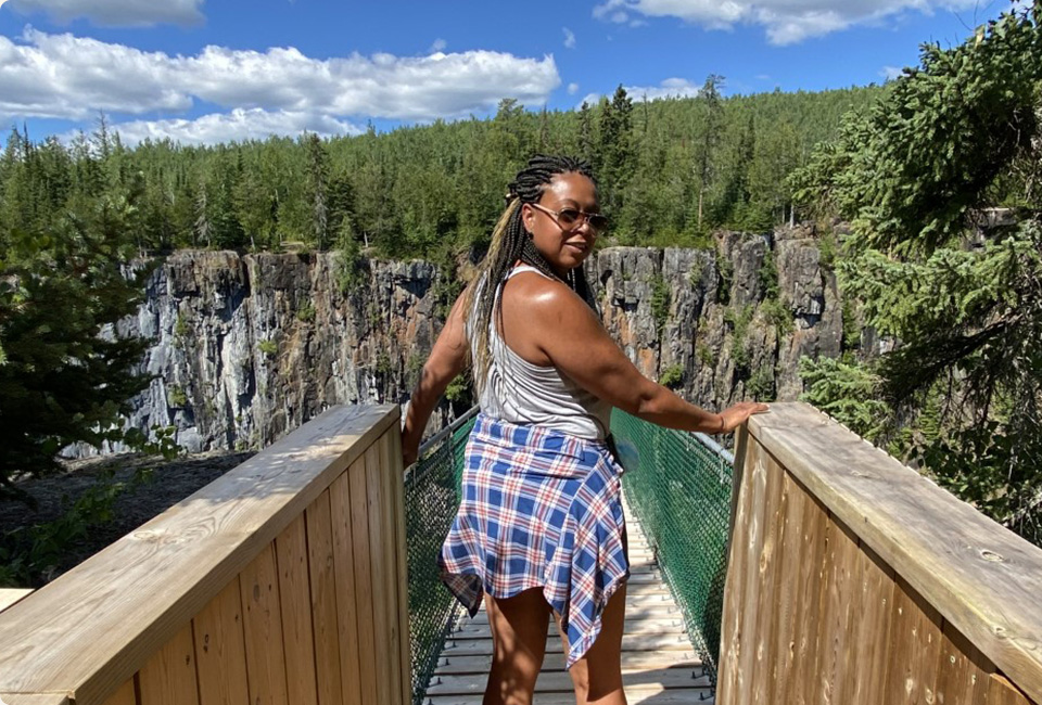 Dionne Daley standing in front of an lake.