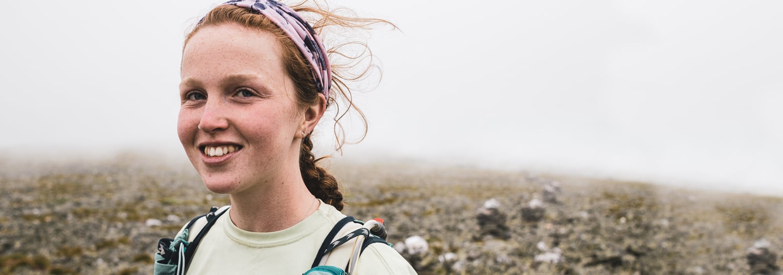 A girl with her hyrdartion pack on, ready to hike.