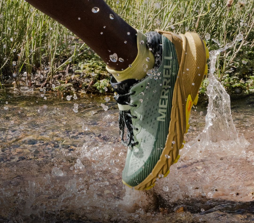 Person tying Merrell running shoes