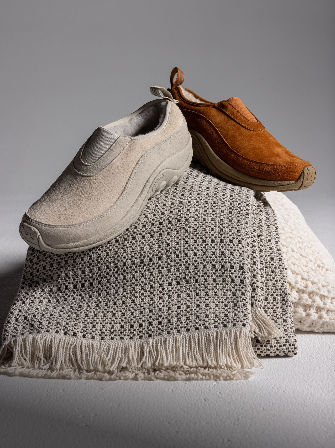 Person wearing Merrell boot on a snowy trail.