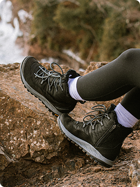 Two legs in waterproof green shoes.