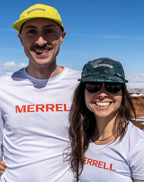 Emilie Mann staying with someone else wearing Merrell T-shirt.