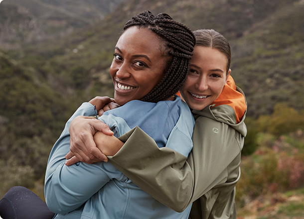 Two people smiling in Merrell gear.