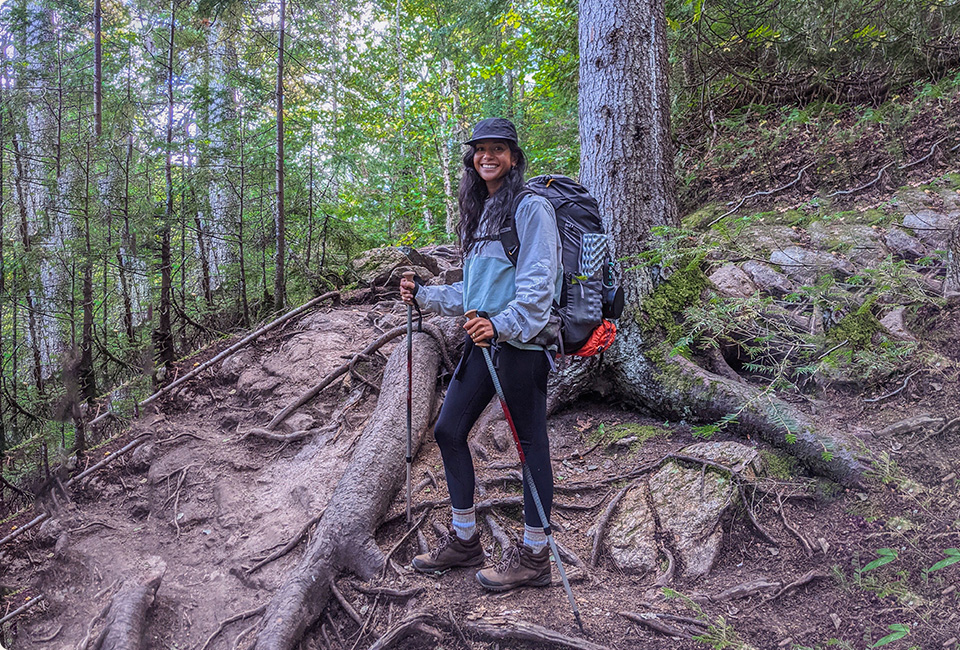 Mary Soueidan standing in the wood and smiling.