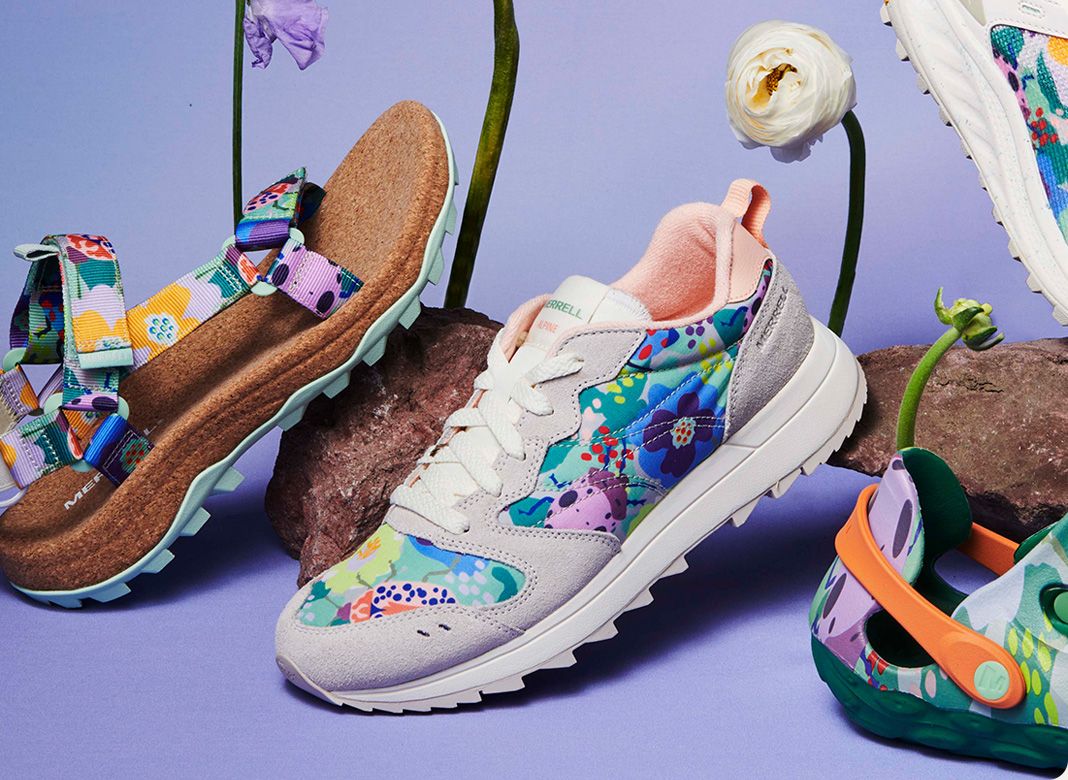 Several pairs of Merrell shoes with flowers.