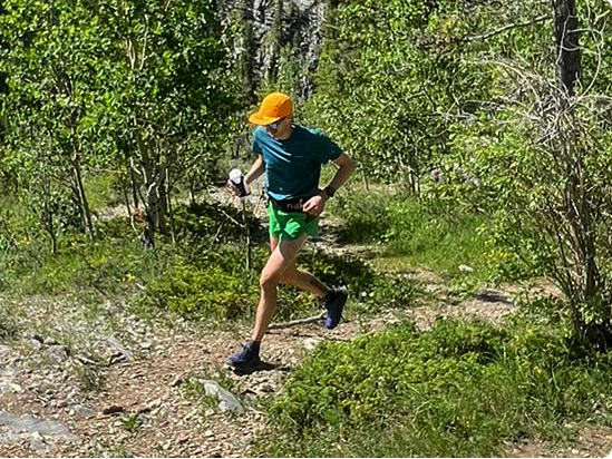 Brandon Miller running on a trail in Merrell gear.