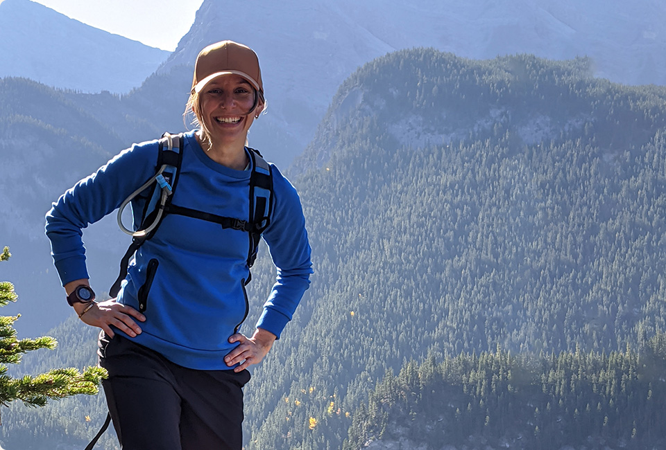 Cassie standing in front of a mountain view.