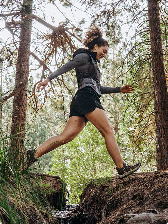 Someone walking in the forest in Merrell shoes.