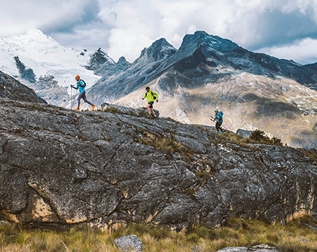 3 people running in the mountians