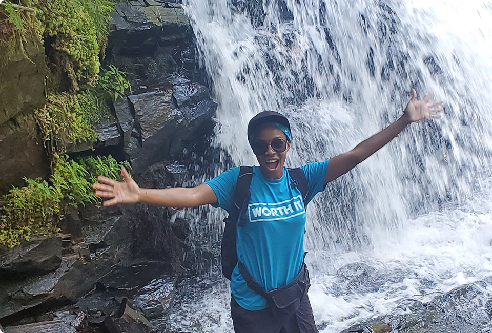 Roen Higgins beside the waterfall.