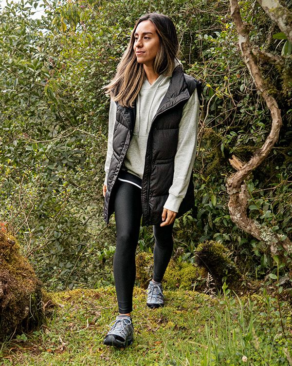 A person walking in a forest wearing Merrell Moab 3 hiking shoes.