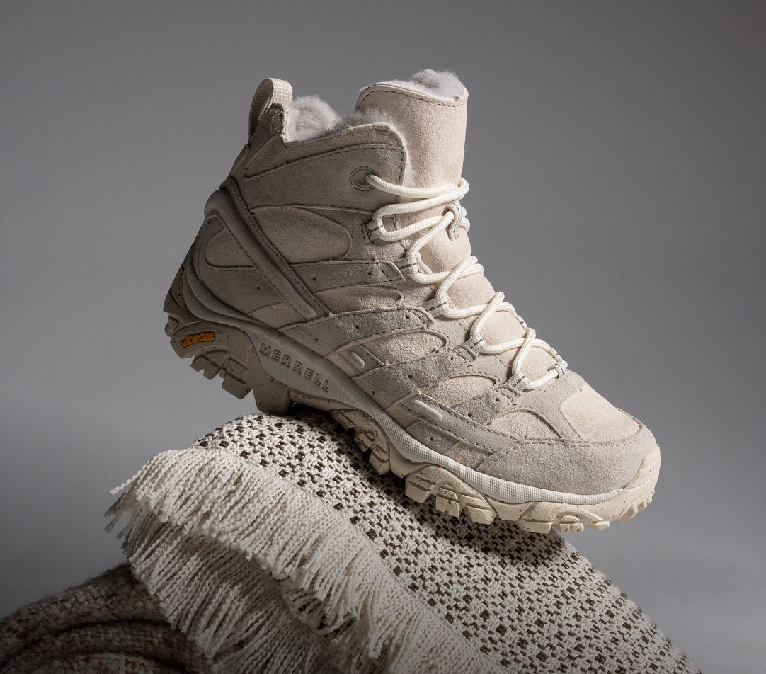 Person tying Merrell running shoes