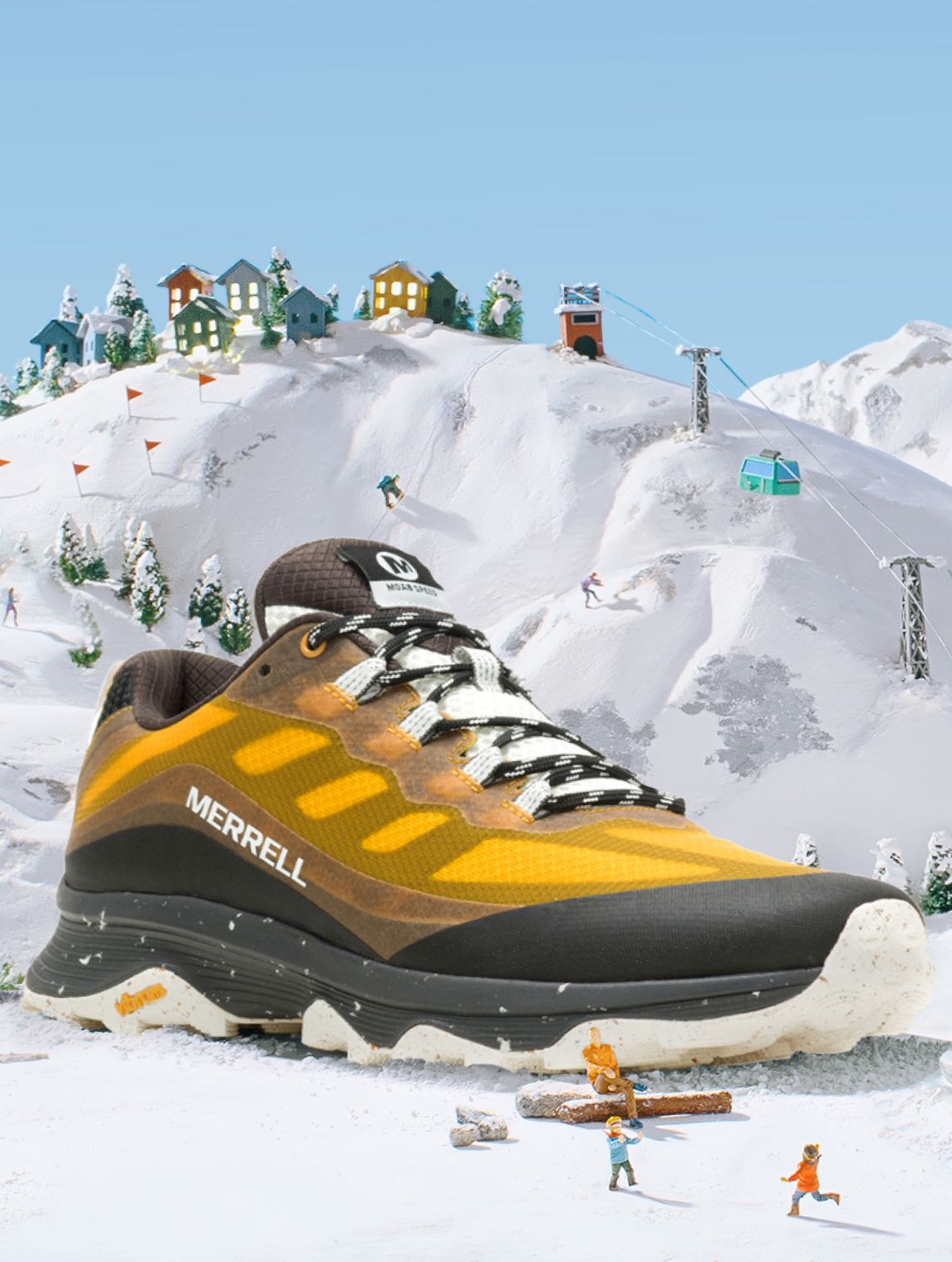 A yellow and black Merrell shoe on a snowy mountain.