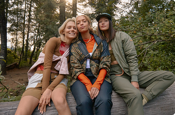 Four people smiling in Merrell gear.