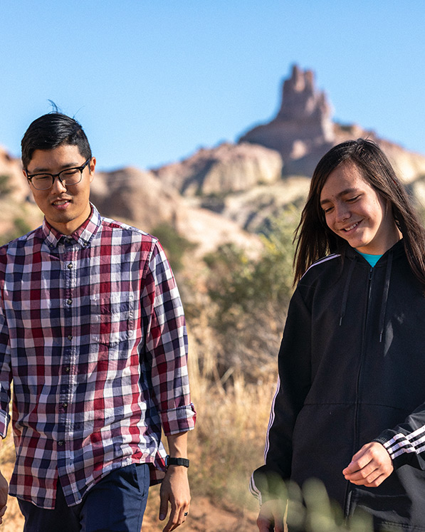 A big brother and little brother hiking in the dessert.