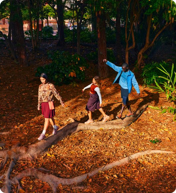 a group of people walking on a tree branch