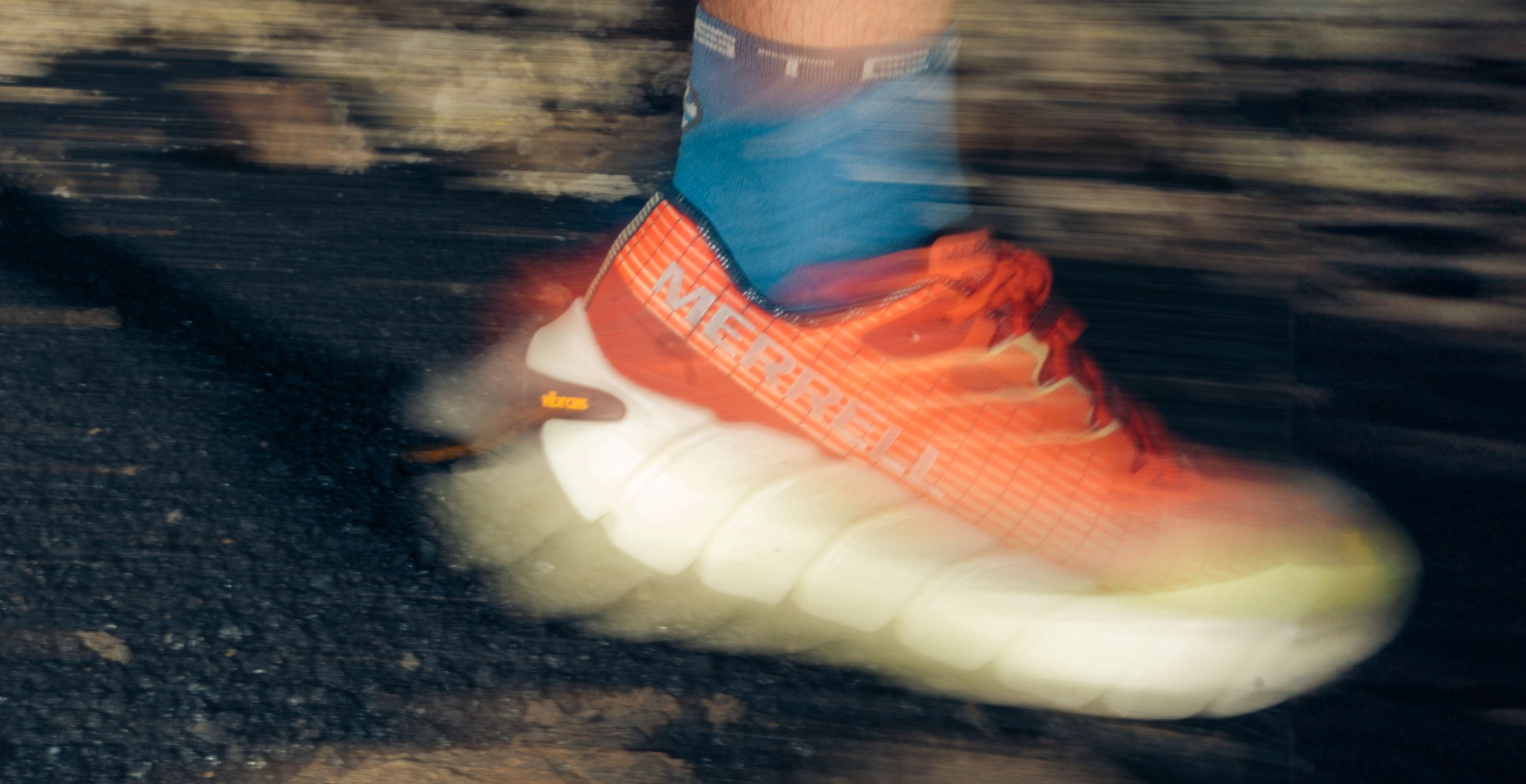 Person walking across the stree wearing Merrell gear