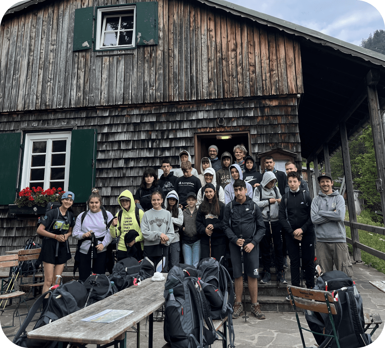 Kids gathered together next to a cabin, about to have an adventure.