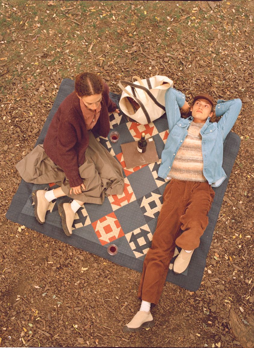 Lifestyle image of 2 people relaxing outside in Merrell gear.f