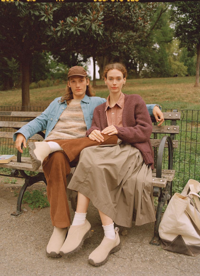 Lifestyle image of 2 people relaxing outside in Merrell gear.f