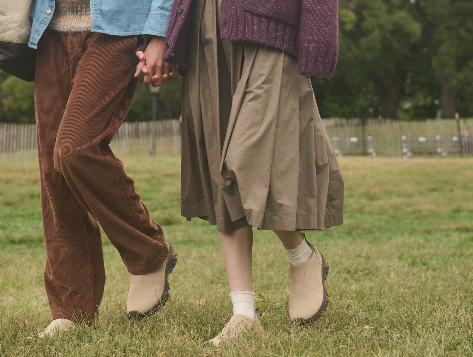 Lifestyle image of 2 people relaxing outside in Merrell gear.f
