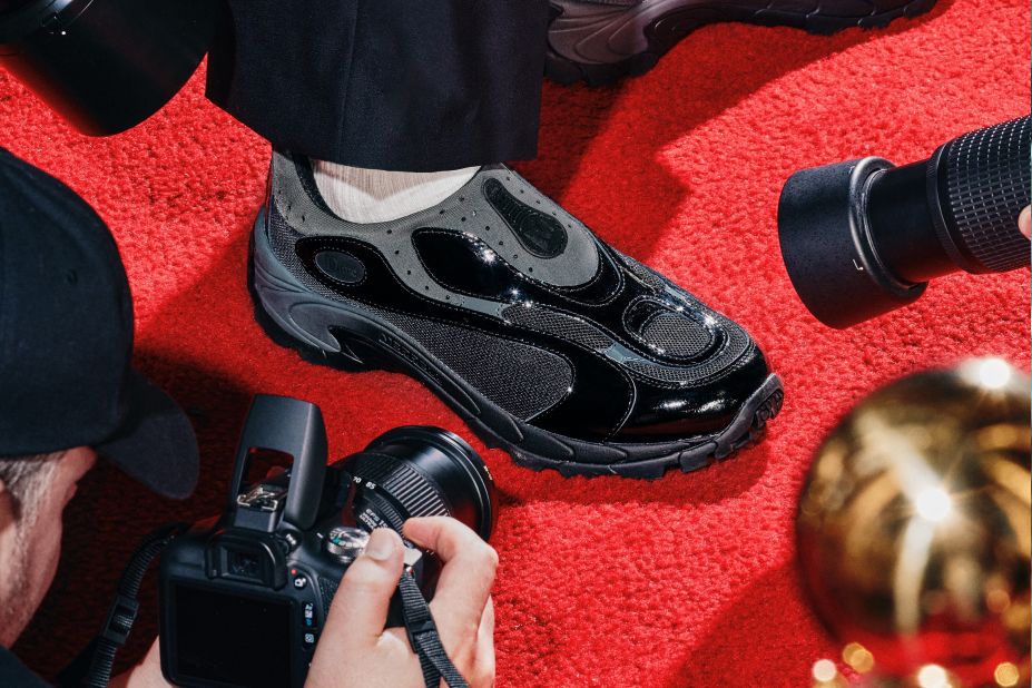 a pair of feet in white and black shoes