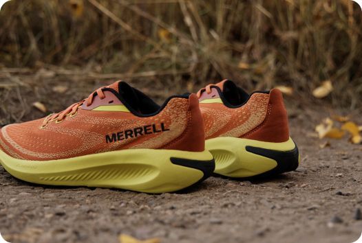 a pair of orange and yellow running shoes