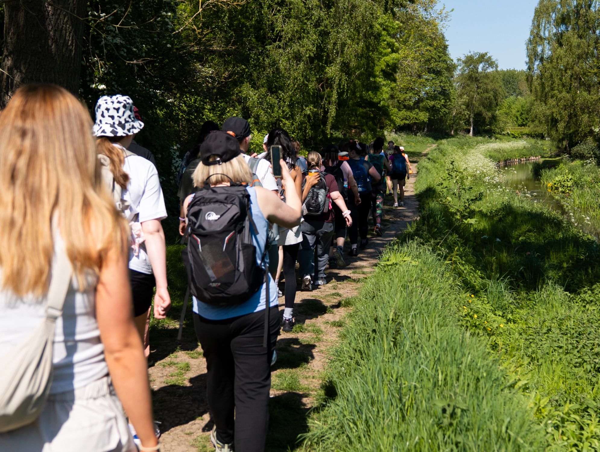 A group of hikers walking along a trail together