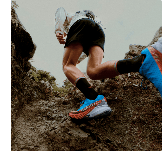 Person running a hiking trail in a pair of Agility Peak 5s.