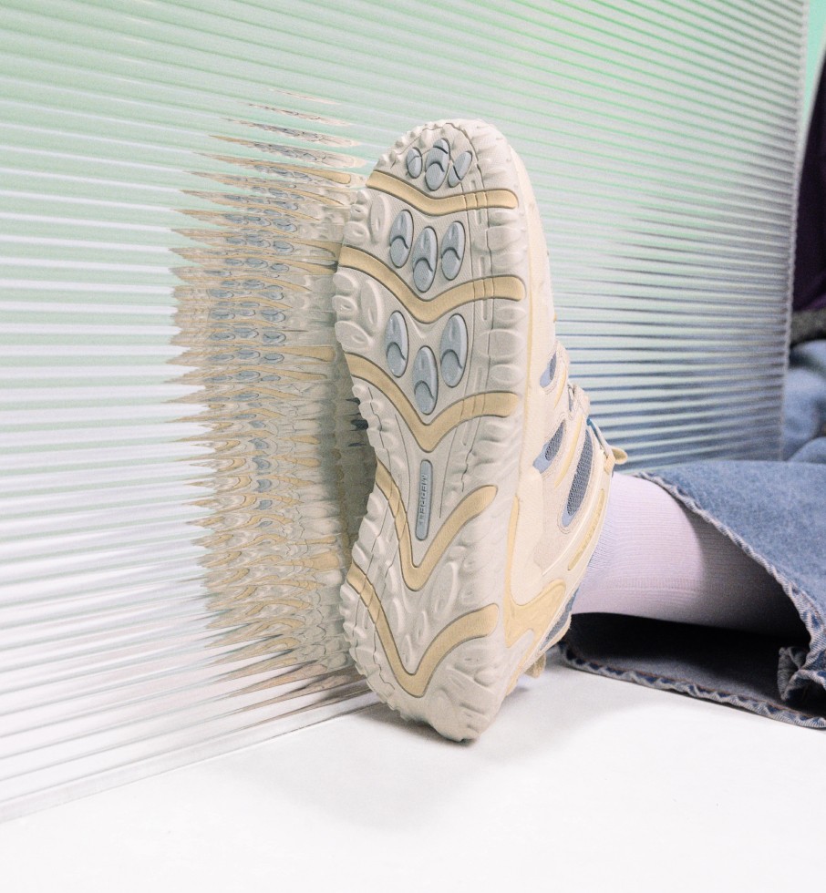 White Cham Redux shoe on a person laying down.