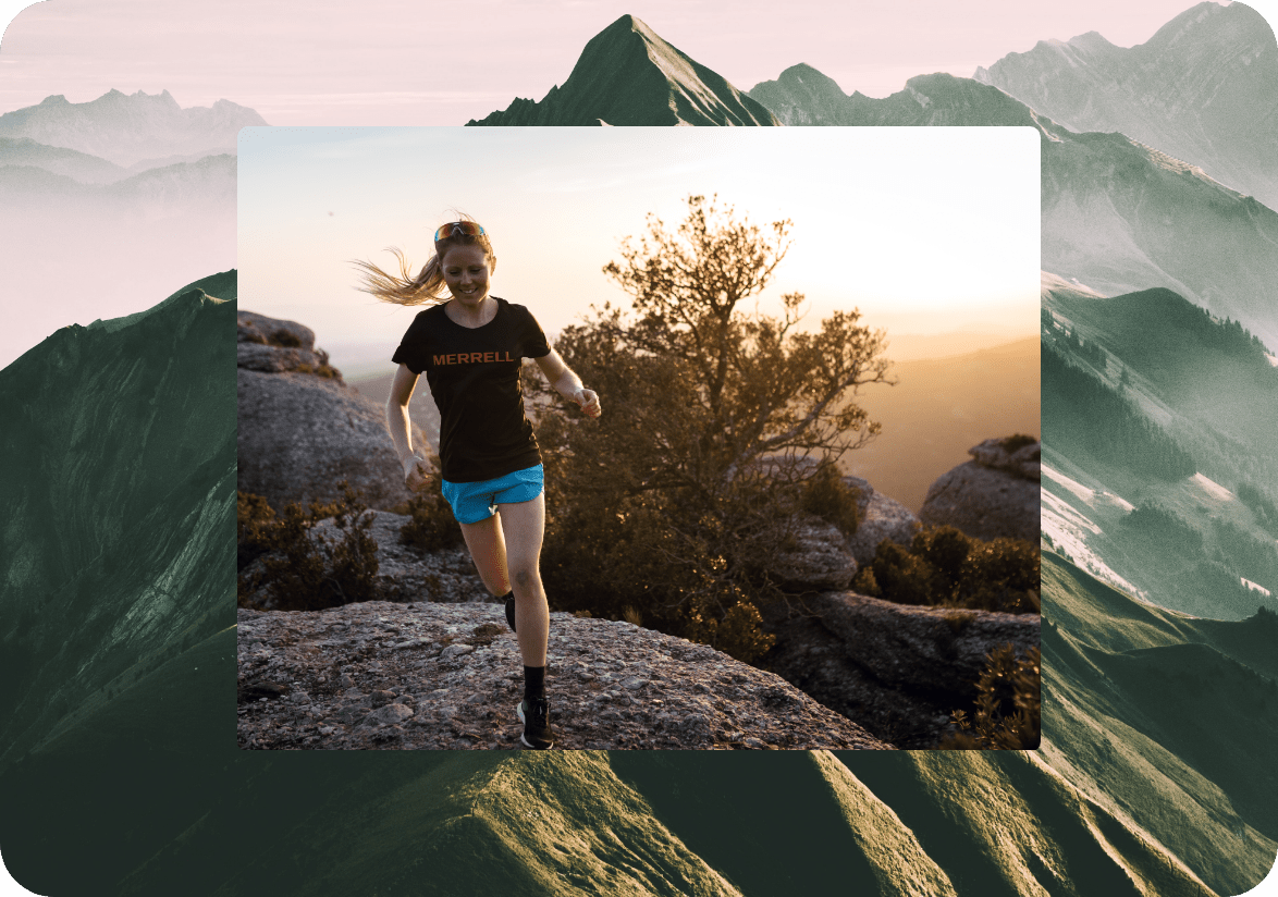 Person running on rocks wearing Merrell apparel and shoes.