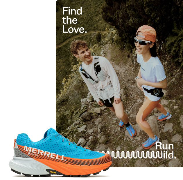 Two people laughing together on a trail.