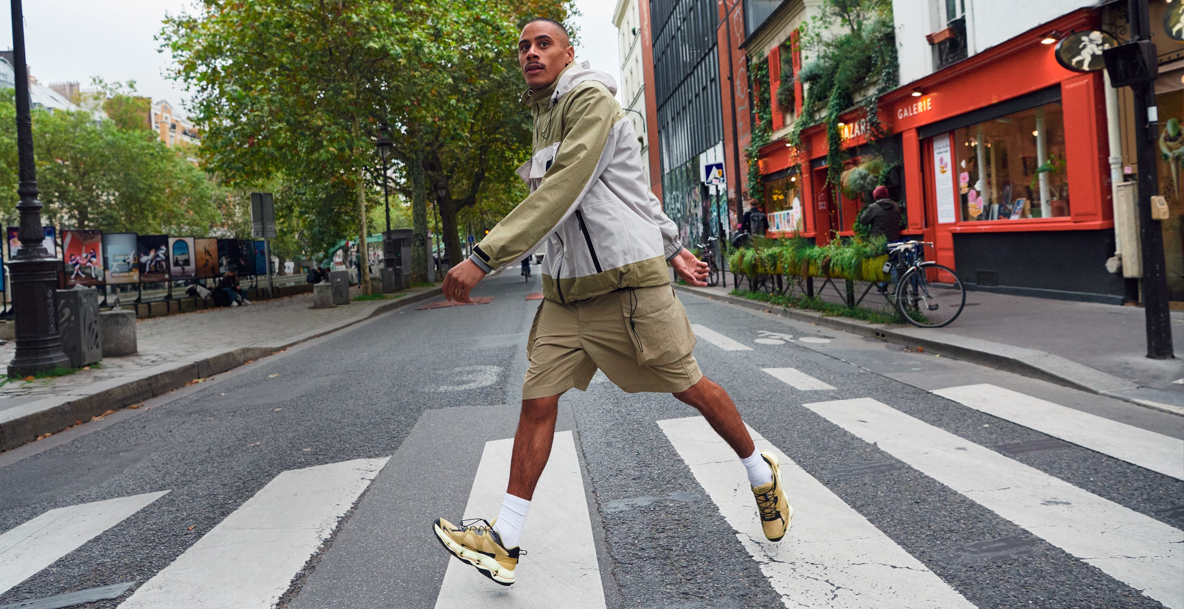 Person walking across the stree wearing Merrell gear