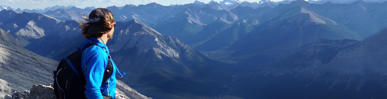 Merrell ambassador, looking off into a vast mountain vista.