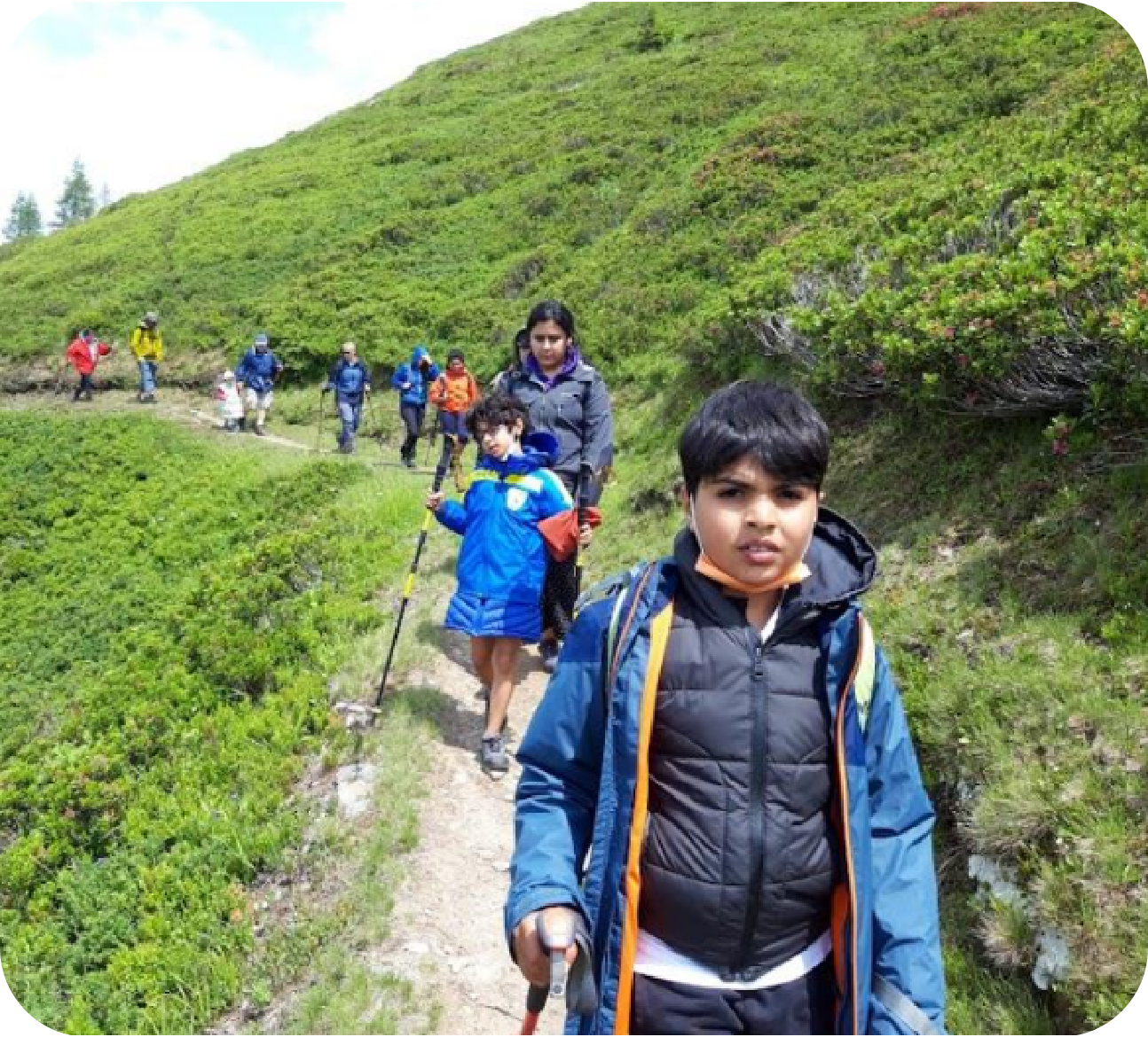 Kids hiking together down a trail.