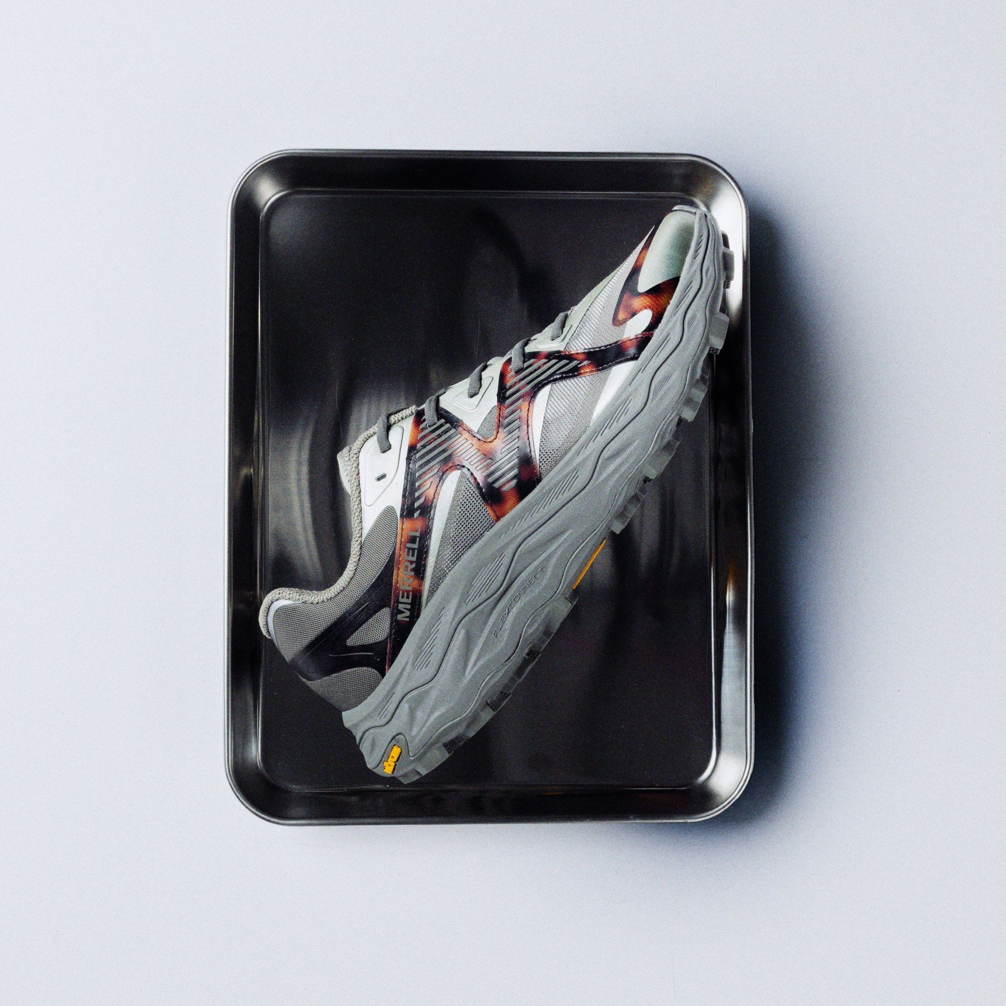 Merrell 1TRL Agility Peak 6 RPT shoe displayed on a metal tray.