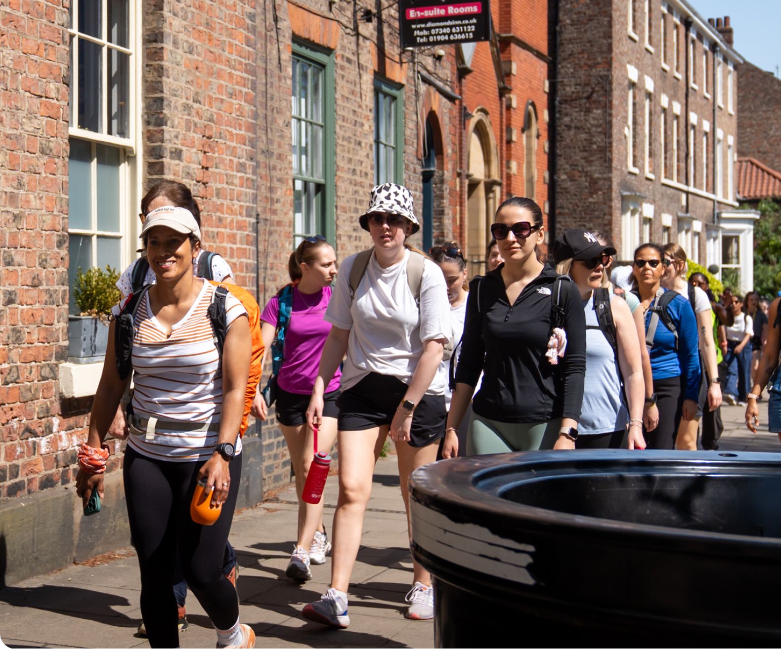 Group of hikers walking through a town