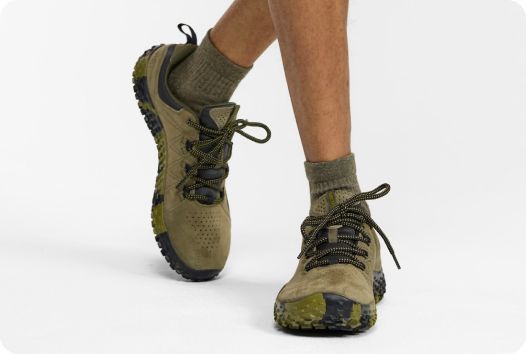 a person's legs wearing green shoes