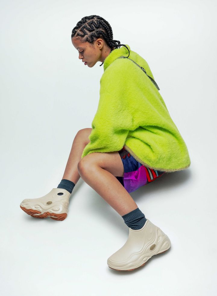 a woman in a green poncho