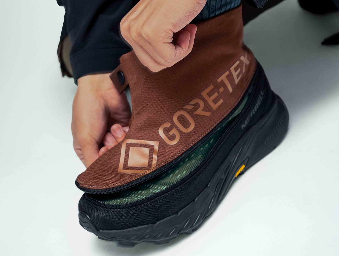 a person putting on a brown shoe