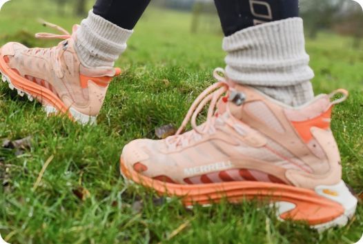 a person's feet in pink shoes