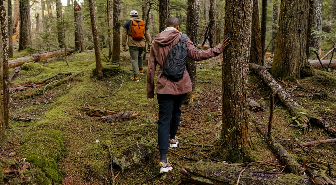 People walking in the woods wearing Merrell gear.