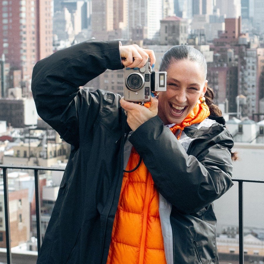 Portrait of photographer Laura Fuchs holding a camera
