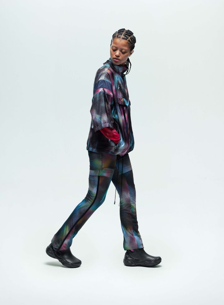 a woman walking in a colorful outfit