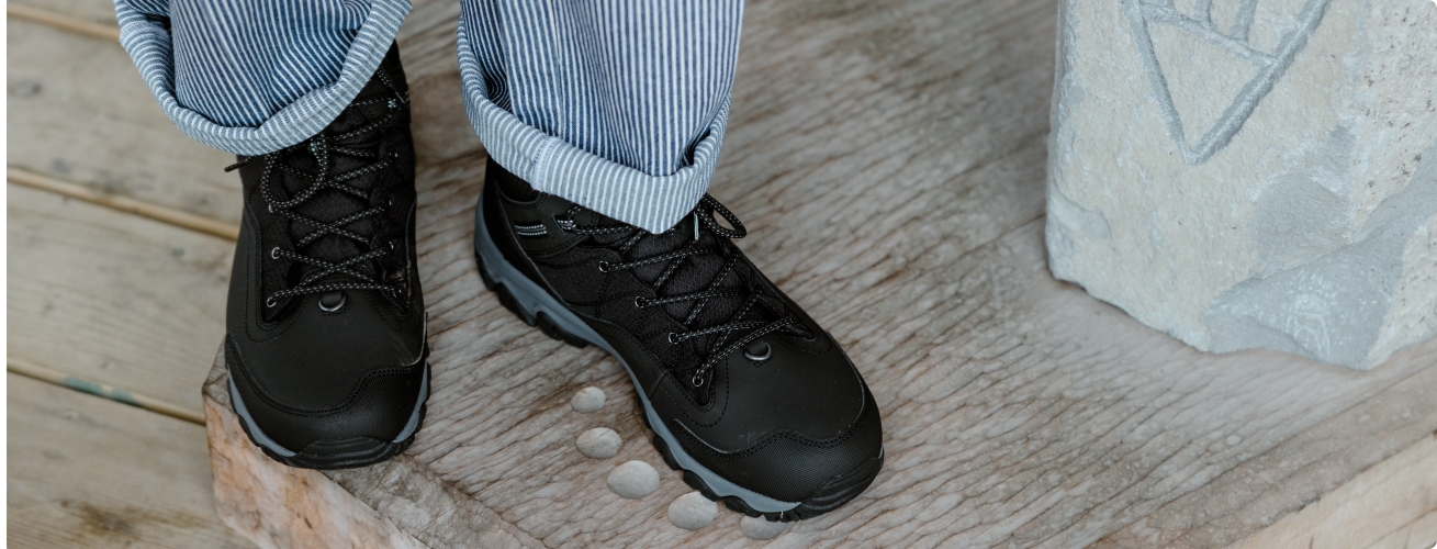 Legs of a person wearing Merrell shoes.