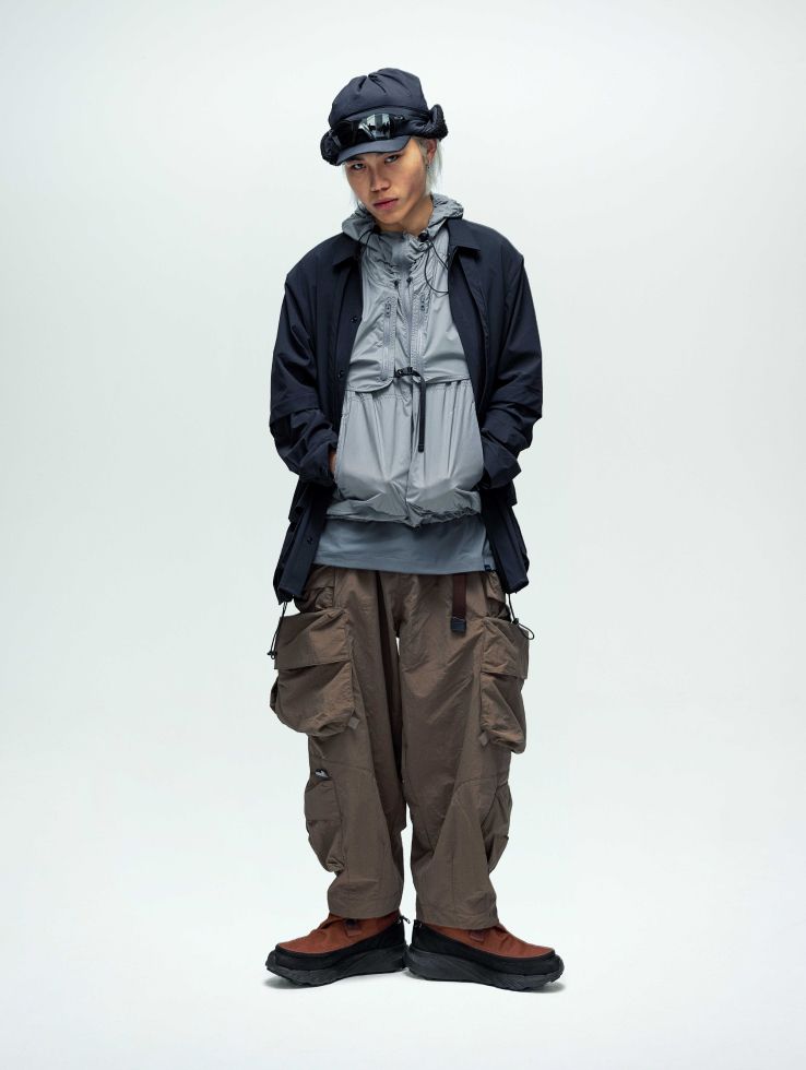 Model standing with green boots