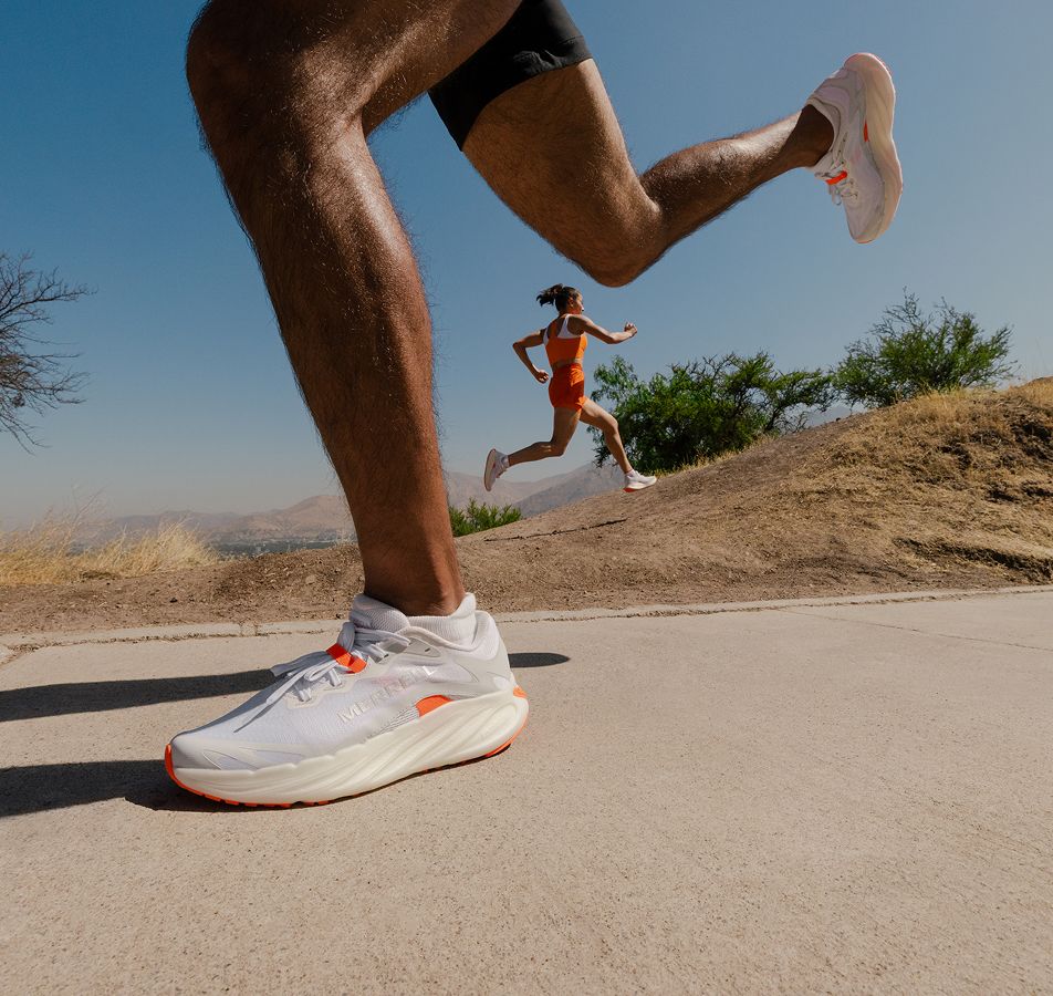 Person tying Merrell running shoes