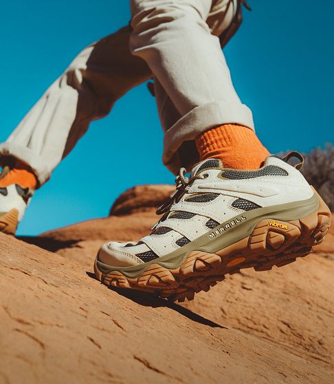 Moab 3's beaing worn while walking on a rocky surface outside.