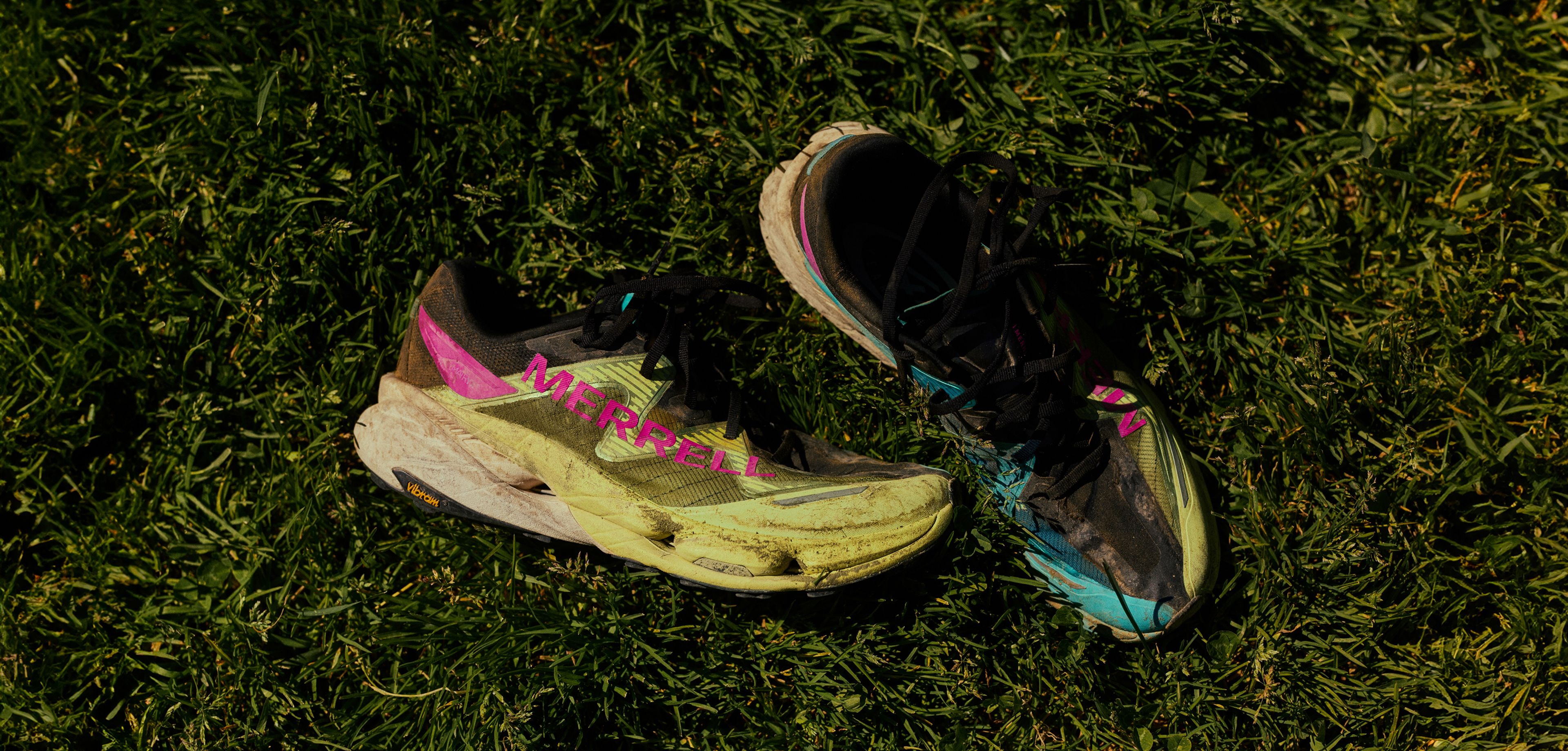 Merrell MTL SpeedARC Peak shoes laying on the grass